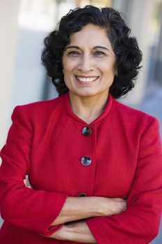 Portrait of a Smiling Indian Businesswoman Looking Directly To Camera With Arms Folded