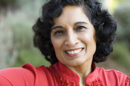 Portrait of a Smiling Mature Indian Woman Looking Directly To Camera
