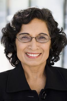 Portrait of a Smiling Mature Indian Businesswoman Looking Directly To Camera