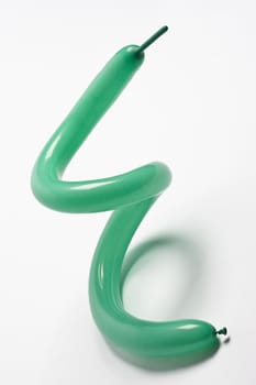 Green balloon twisted in the form of a spiral