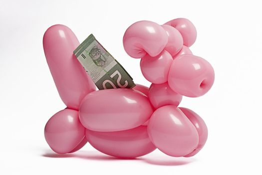 Pink balloon biggy bank with twenty canadian dollard inserted in it