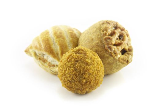 Small tasty pork pie with small sausage roll and scotch egg on a reflective white background