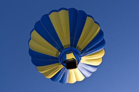 Early morning lift off a multi-coloured hot air ballon