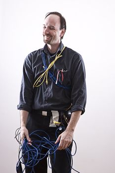 Computer technician in full cable gear laughing