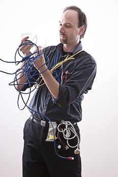 Computer technician looking confuse looking at expose network cable