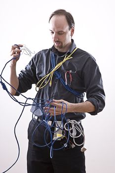 Computer technician in full cable gear laughing