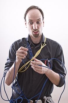 technician lost by wires in his hand