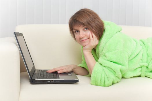 The young woman with the laptop on a sofa