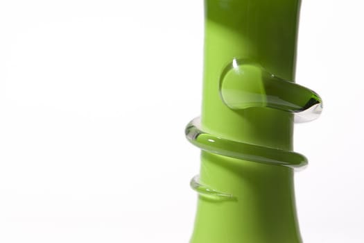 decorative glass snake on the stem of a green vase