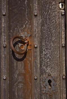 Old and new keyholes help secure the door to a medieval Wiltshire church  