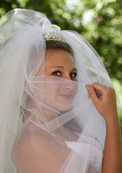 The bride is covered in a veil tiara
