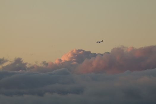 Plane and low cloud at sunset