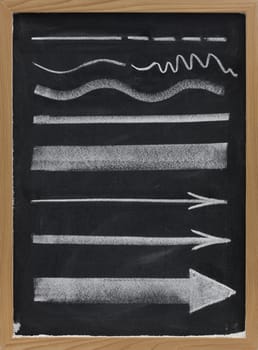 design elements, lines and arrows with different thickness, white chalk sketch on blackboard 