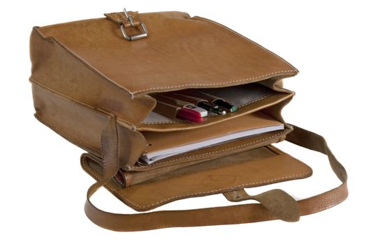 old leather school bag with scratches and stains - opened showing pens and notebook, isolated on white