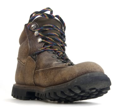 heavy worn out hiking boot with colorful laces on white background, low angle distorted perspective