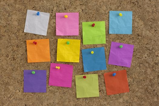 colorful blank notes pinned on cork bulletin board