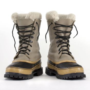 a pair of heavy snow boots on white background, low angle perspective