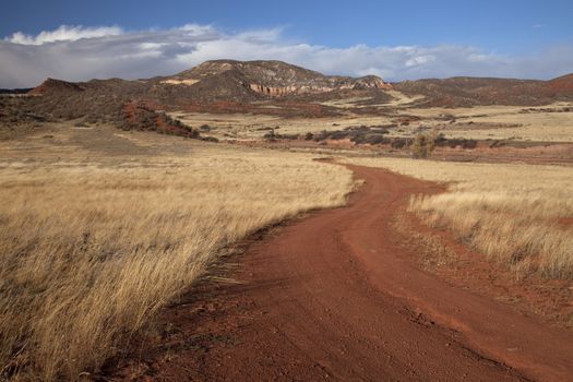 windy road in Red Mountain Open Space in northern Colorado (Larimer County), fall scenery with dry grass moved by wind