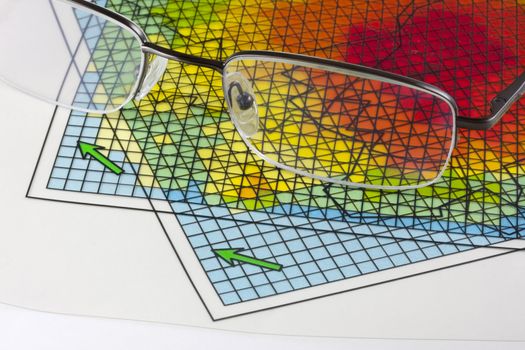 reading glasses and two overlaping transparencies with gridded computer model simulation results - science abstract