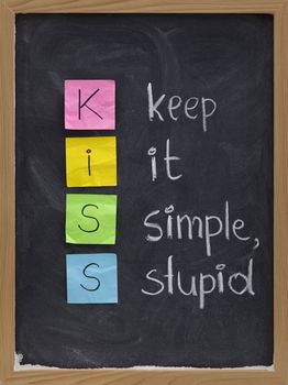 KISS keep it simple, stupid - design principle presented with sticky notes and white chalk handwriting on blackboard