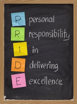 PRIDE (personal responsibility in delivering excellence) concept on blackboard, color sticky notes and white chalk handwriting