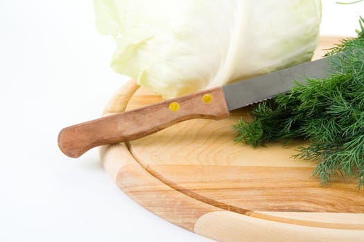 Cabbage and fennel on a wooden cutting board on a white background  