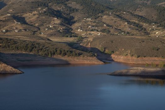 residential luxury houses on hills above Horsetooth Reservoir near Fort Collins in northern Colorado, early morning fall scenery