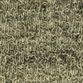 close-up of white, gray, brown handmade knitted wool sweater texture
