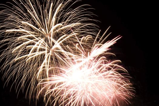 Firework display against black sky