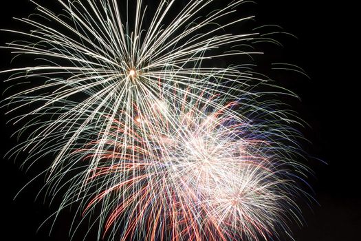 Firework display against black sky