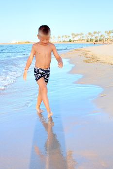 Running on beach in sunset coastline