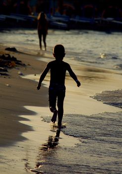 Running on beach in sunset coastline