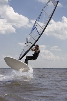 Windsurfer doing a jump trick in the water