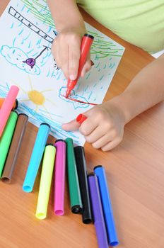 Caucasian boy drawing on paper with crayons