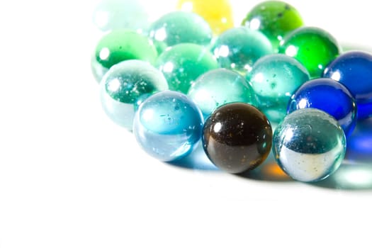 Studio shot of varicolored beautiful glass marbles on a white background