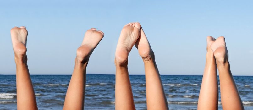 lovely legs on the beach on blue sky