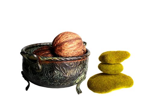 Decorative aromatic nuts in a metal decorative bowl with stones covered with a moss.