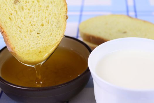 Cornbread with milk and honey on a linen napkin removed close up