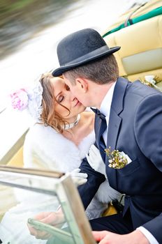 the newly married couple drive retro wedding car