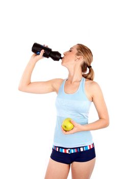 Woman drinking water and holding apple isoalted