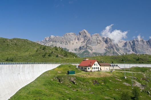 summer view of lake Cavia dam near San Pellegrino pass, Trentino, Italy 