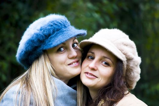 two cute girls having fun outdoors in autumn