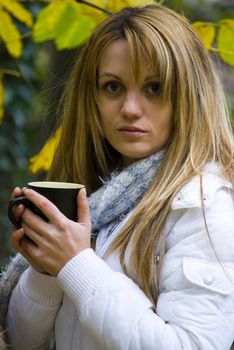 cute girls drinking hot tea in cold autumn