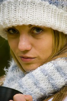 cute girl drinking hot tea in cold autumn