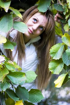 beautiful girl holding colorful autumn leaves in hands