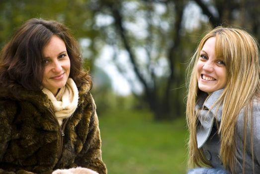 two cute smiling women outdoors in autumn