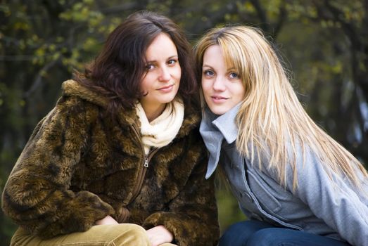 two cute smiling women outdoors in autumn