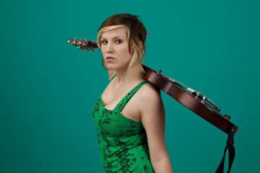 punk girl with an electric guitar on a green background