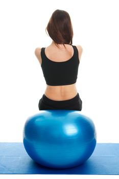 Fitness women exercising on fitness ball Shot from behind. Isolated on white