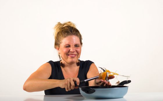 Cheeky blond playing around with eggs and pans